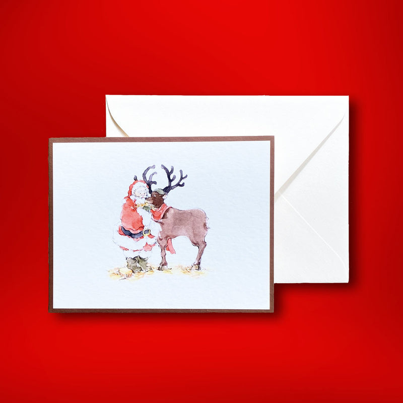 Santa is tending to his favourite reindeer in this lovely watercolour by Katherine Yan. Printed onto white landscape cards with a brown border, these Christmas cards come with plain white envelopes in our branded boxes