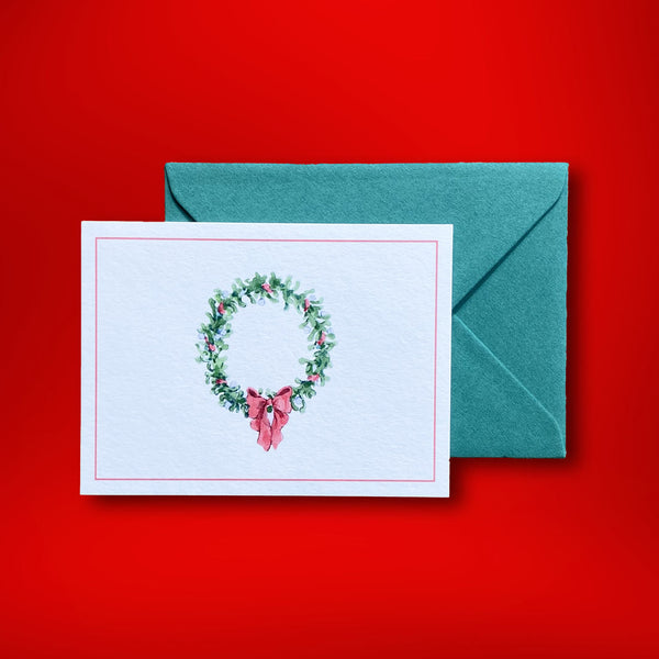 The traditional christmas wreath of this landscape folded christmas card. Painted by Katherine Yan for Pemberly Fox they are supplied with emerald green C6 envelopes in our branded box.